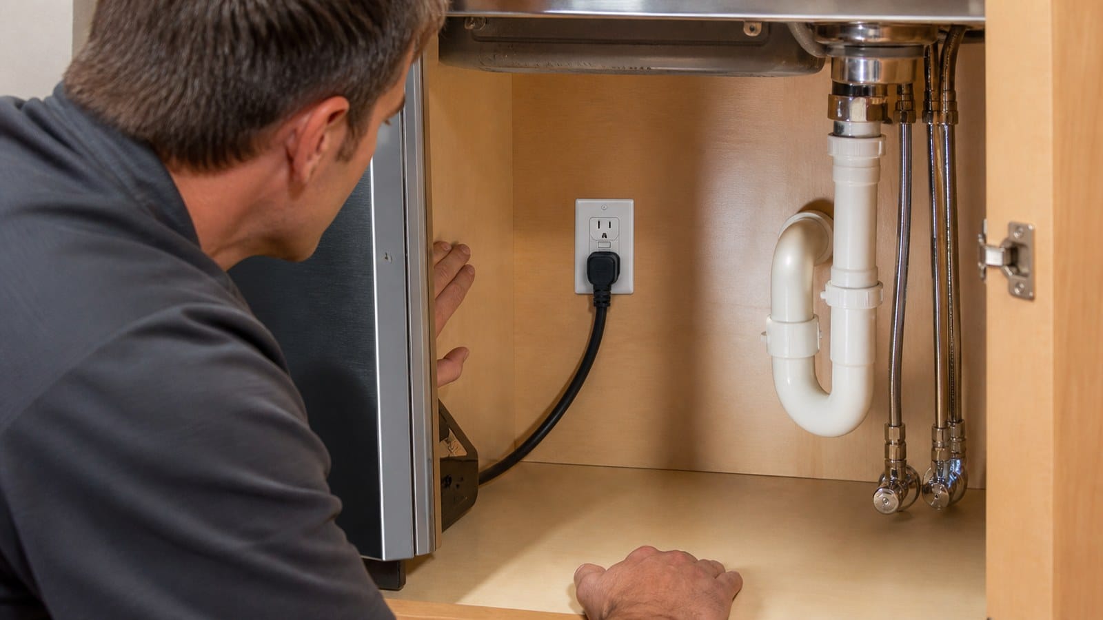 Dishwasher power cord connected to an accessible GFCI receptacle in a dry sink-base cabinet